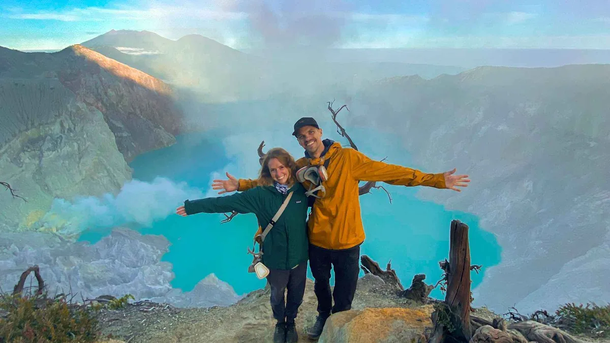 Hikers with headlamps on the crater rim at dawn on a Mount Ijen tour from Banyuwangi