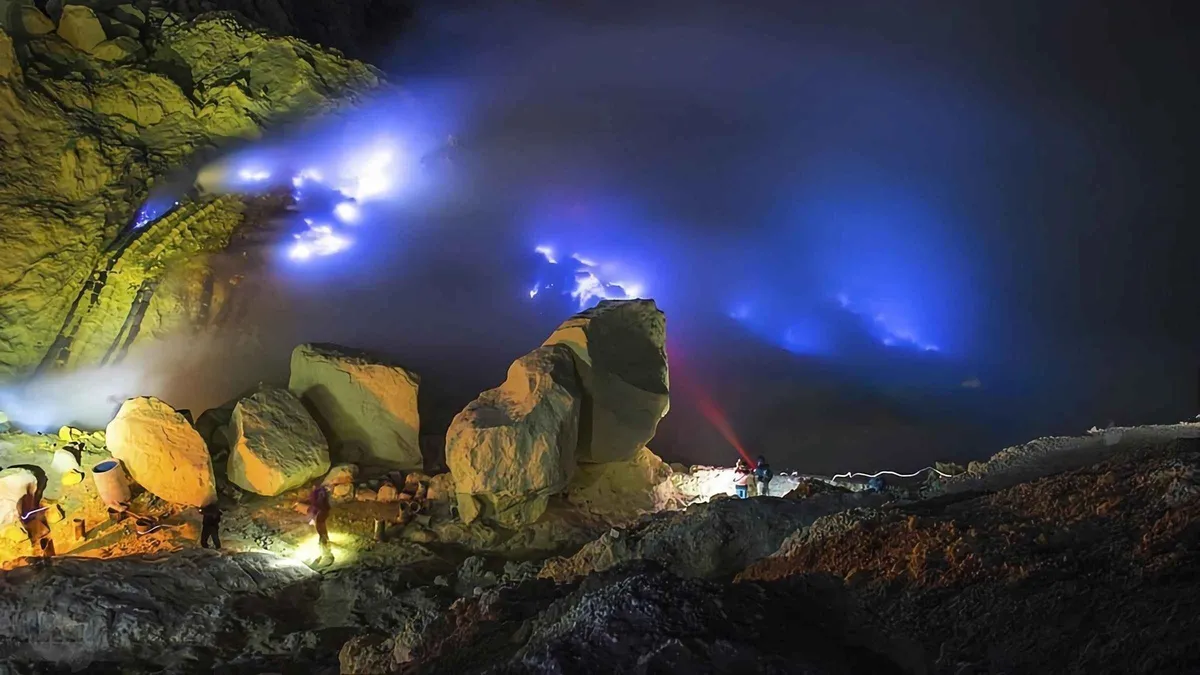 Guide and traveller on the dark trail during a private Mount Ijen tour from Bali or Banyuwangi